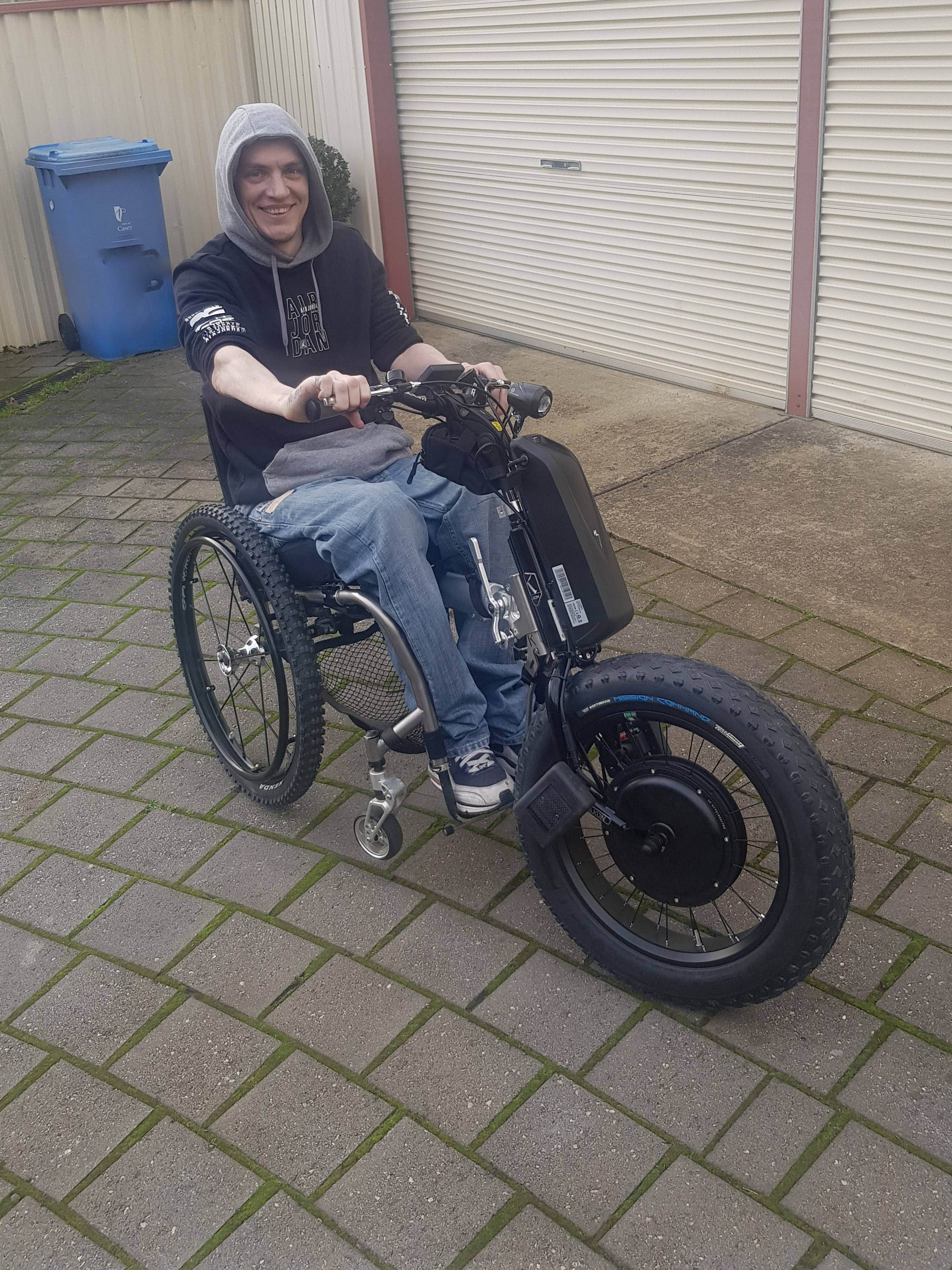 Ed in his wheelchair with the Klaxon Monster attachment, huge smile on his face
